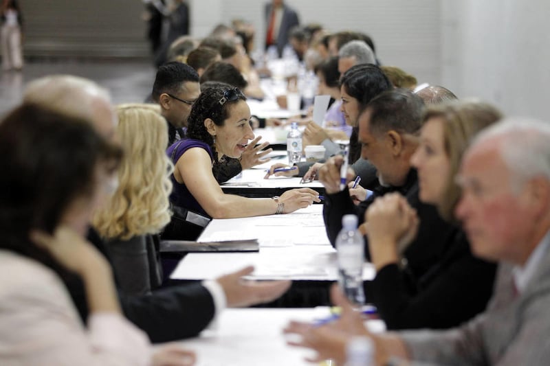 In this June 13, 2012 photo, job seekers have their resumes reviewed at a job fair expo in Anaheim, Calif.