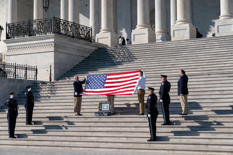 A flag is folded in Washington to observe the 100th anniversary of the Tomb of the Unknown Soldier.