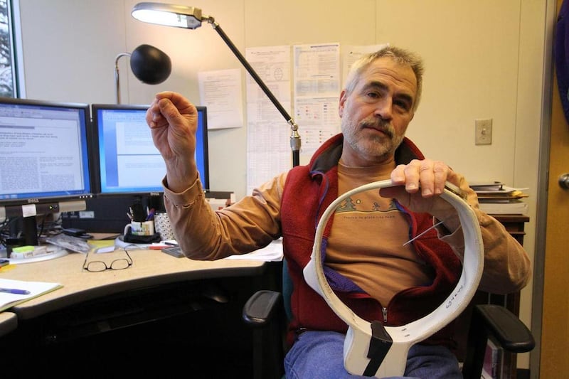 In this Jan. 28, 2011 photo, research zoologist George M. Durner of the U.S. Geological Survey discusses the components of a radio collar used in 2008 Beaufort Sea polar bear research, at his office in Anchorage, Alaska.