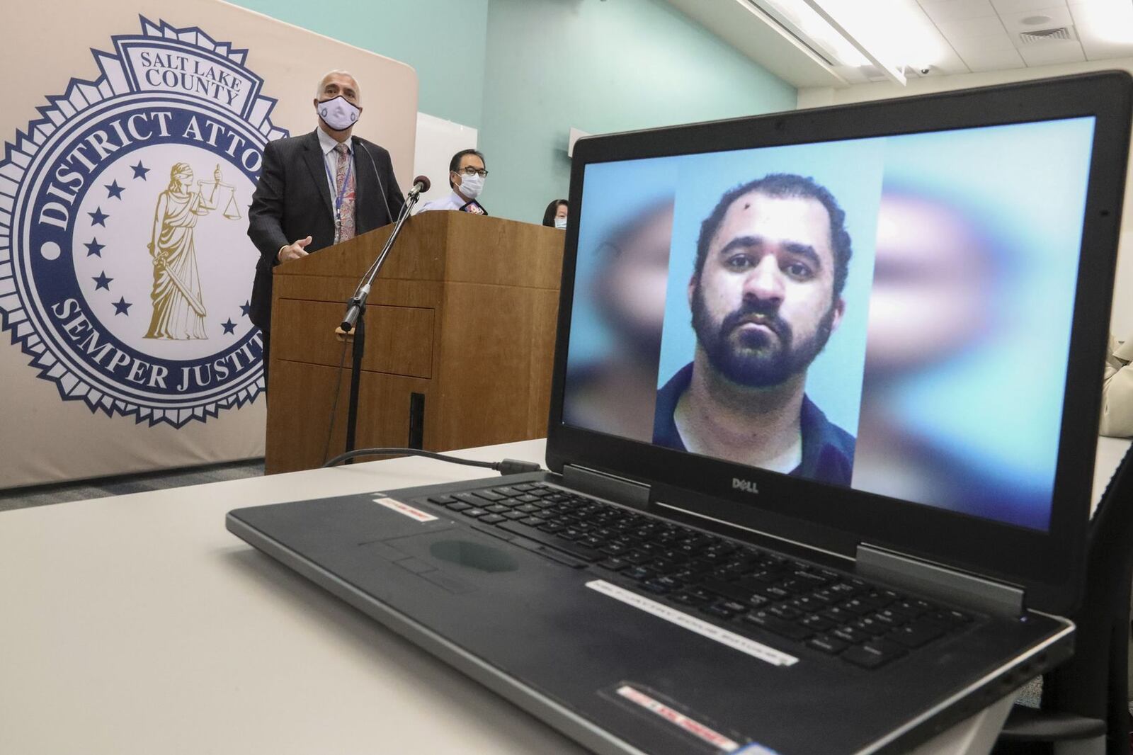 Salt Lake County District Attorney Sim Gill, left, announces aggravated murder charges against Adam Antonio Spencer Durborow.