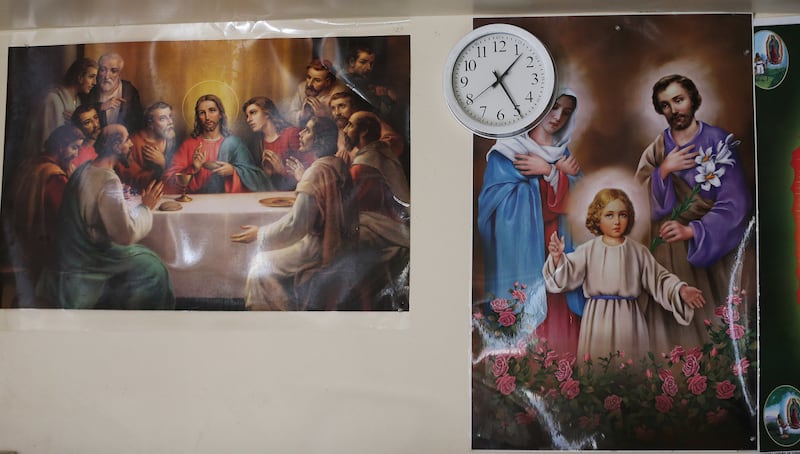 Religious photos hang in the apartment of Congolese refugees George and Amisa Ngunza in Salt Lake City on Nov. 5, 2017.