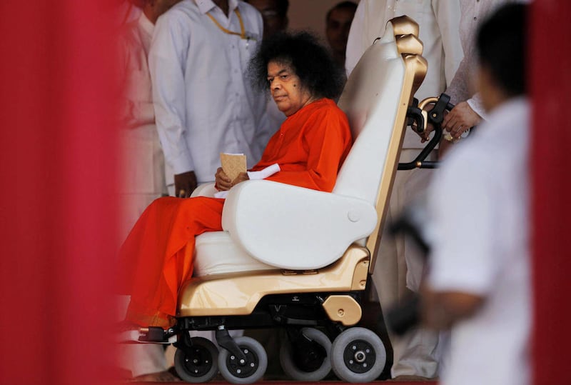 In this April 10, 2010 photo, Indian spiritual leader Sathya Sai Baba sits in a wheel chair at a function to meet his devotees in New Delhi, India. Baba, considered a living god by millions of followers worldwide, died Sunday, April 24, 2011 in a hospital