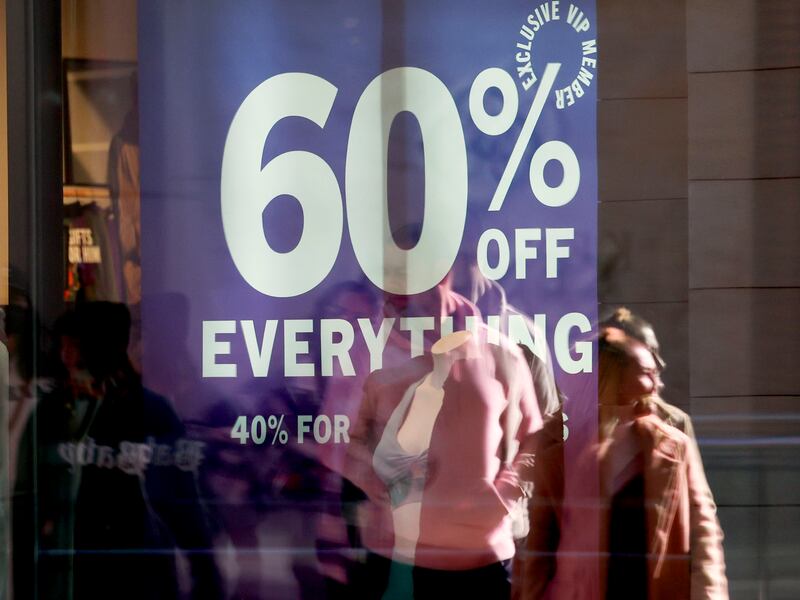 Shoppers walk past sale signs at the City Creek Center in Salt Lake City on Friday, Nov. 25, 2022.