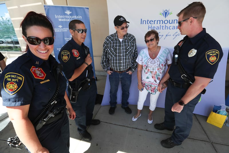 John Lindsey and his his fiancee, Grett Williams, meet with South Salt Lake firefighters at Intermountain Medical Center in Murray on Monday, May 20, 2019. Lindsey thanked the first responders and other motorists who helped save his life after he suffered