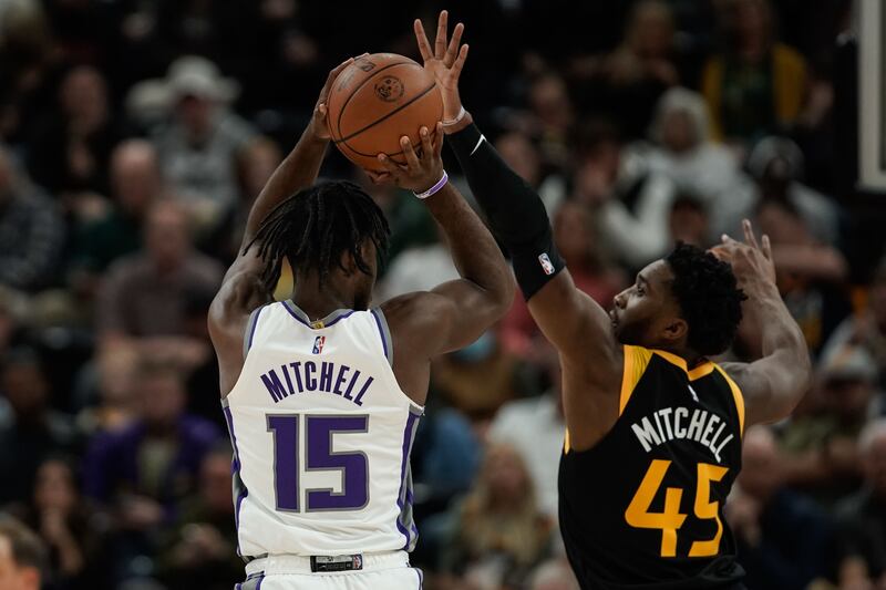 Sacramento’s Davion Mitchell goes for a 3-pointer as Utah’s Donovan Mitchell defends during game in Salt Lake City.