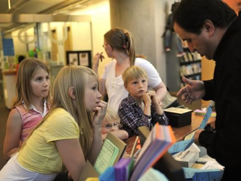 Kids sign up for a children\'s summer reading program at the Salt Lake City Library.