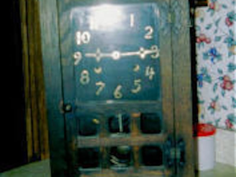 This attractive Mission-style clock has flared feet and a cornice top.