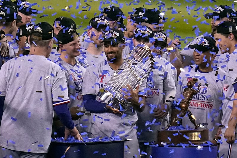 Texas Rangers’ Marcus Semien holds the trophy as the Texas Rangers celebrate after winning the World Series against the Arizona Diamondbacks Wednesday, Nov. 1, 2023.