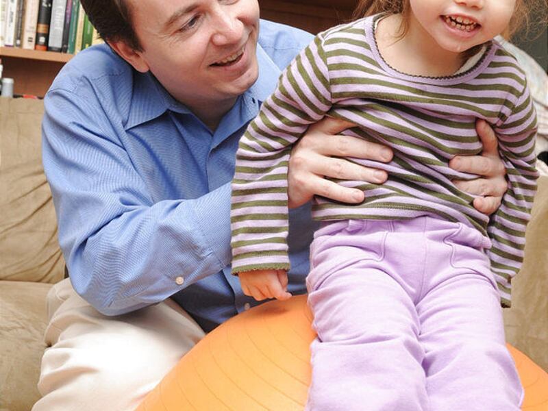 Patrick Donohue holds Sarah Jane, who suffered broken bones and brain damage at 5 days old.