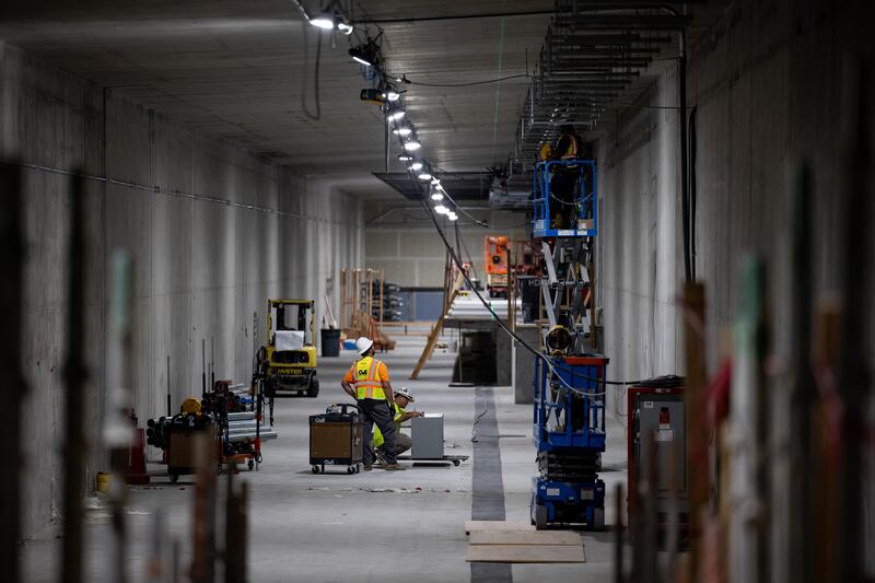 Crews work in one of two train tunnels that flank the central tunnel at the Salt Lake City International Airport on Aug. 2, 2022.