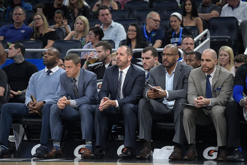 Orlando Magic head coach Frank Vogel, center, watches from the bench with, from left, athletic trainer Keon Weise, assistant coach Chad Forcier, assistant coach Corliss Williamson, and assistant coach Jay Hernandez