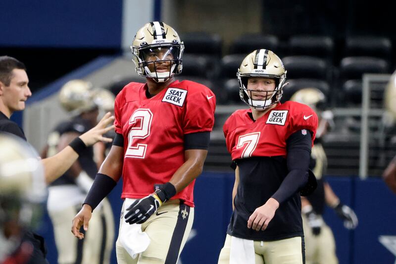 New Orleans Saints quarterbacks Jameis Winston (2) and Taysom Hill (7) line up during an NFL football workout.