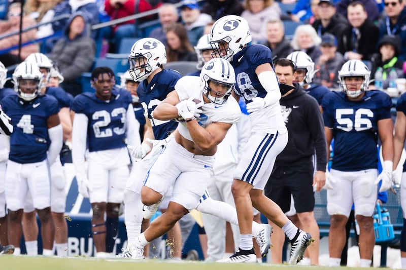 BYU Cougars running back Hinckley Ropati (7) dodges a tackle during the BYU Blue vs. White scrimmage in Provo on March 31, 2023.