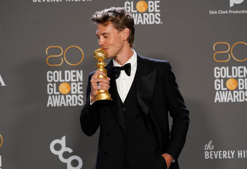 Austin Butler poses with the award for best performance by an actor in a motion picture, drama, for “Elvis” at the Golden Globe Awards.