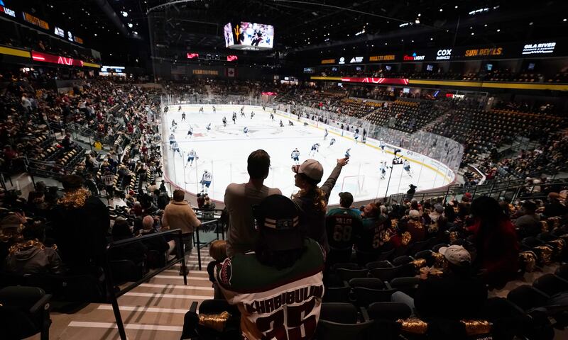 The Arizona Coyotes warm up before a game at Mullett Arena in Tempe.