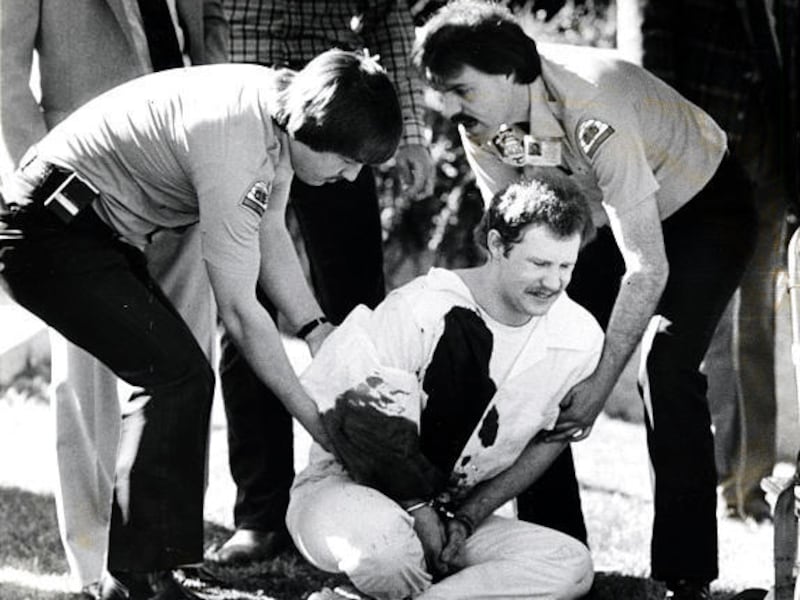 Ronnie Lee Gardner grimaces with pain from his gunshot wound on the lawn at the Metropolitan Hall of Justice after his recapture on April 2, 1985.