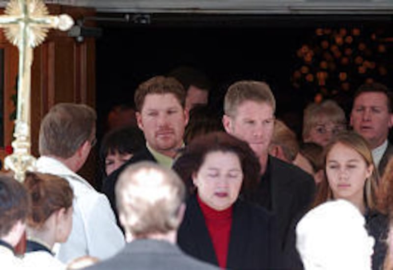 Green Bay Packers quarterback Brett Favre, center right, and his brother Scott Favre, center left, leave funeral services for their father Irvin Favre at St. Paul Catholic Church in Pass Christian, Miss.