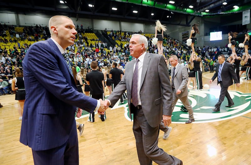 Utah Valley Wolverines head coach Mark Pope and Brigham Young Cougars head coach Dave Rose shake hands after the game as UVU and BYU played a college basketball game in the UCCU Center at UVU in Orem, Utah on Wednesday, Nov. 29, 2017. BYU won 85-58.