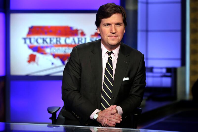 In this March 2, 2017 file photo, Tucker Carlson, host of “Tucker Carlson Tonight,” poses for photos in a Fox News Channel studio, in New York.