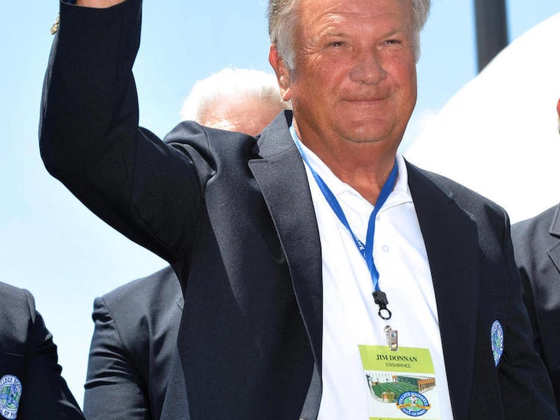 FILE - In this July 18, 2009, file photo, Jim Donnan, former coach at Marshall and Georgia 1990-2000, waves to the crowd after receiving his blazer during the College Hall of Fame pep rally in South Bend, Ind. The U.S. Securities and Exchange Commission i