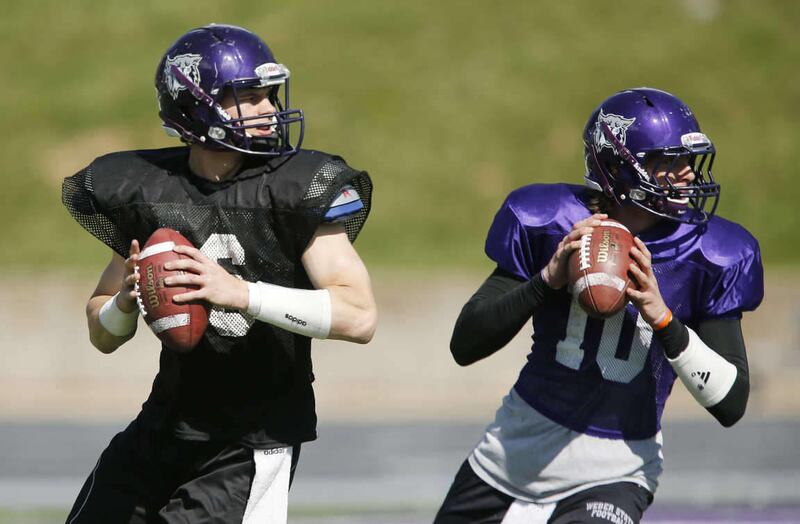 Weber State Wildcats quarterbacks Austin Chipoletti (16) and Jadrian Clark (10) throw during practice in Ogden Thursday, April 10, 2014.