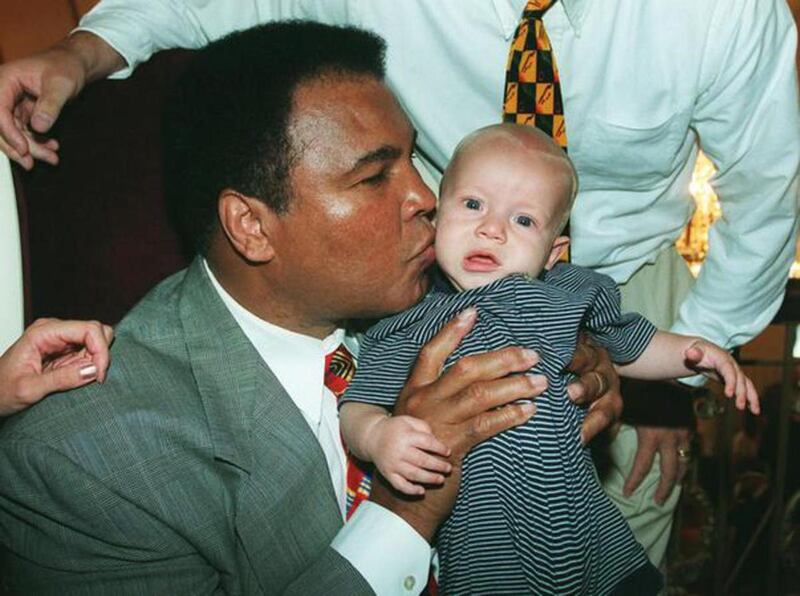 FILE: Muhammad Ali kisses Carson Whitlock, grandson to Utah GOP Sen. Orrin Hatch, prior to program at the Capitol Theatre. Ali died Friday, June 3, 2016, at age 74.