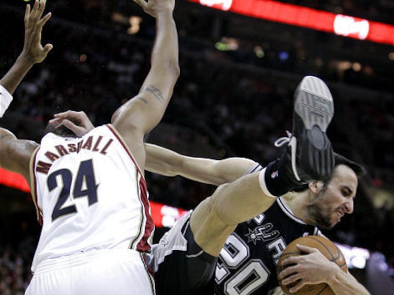 San Antonio's Manu Ginobili, (20) smacks Cleveland's Donyell Marshall while grabbing a rebound during his hot-shooting game.