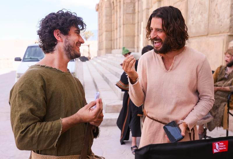 George Harrison Xanthis, who plays John, laughs with Jonathan Roumie, who plays Jesus, on the set of “The Chosen.”