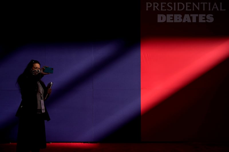 A member of the production team uses a cell phone to make images of the hall ahead of the first presidential debate between Republican candidate President Donald Trump and Democratic candidate former Vice President Joe Biden at the Health Education Campus of Case Western Reserve University, Tuesday, Sept. 29, 2020, in Cleveland.