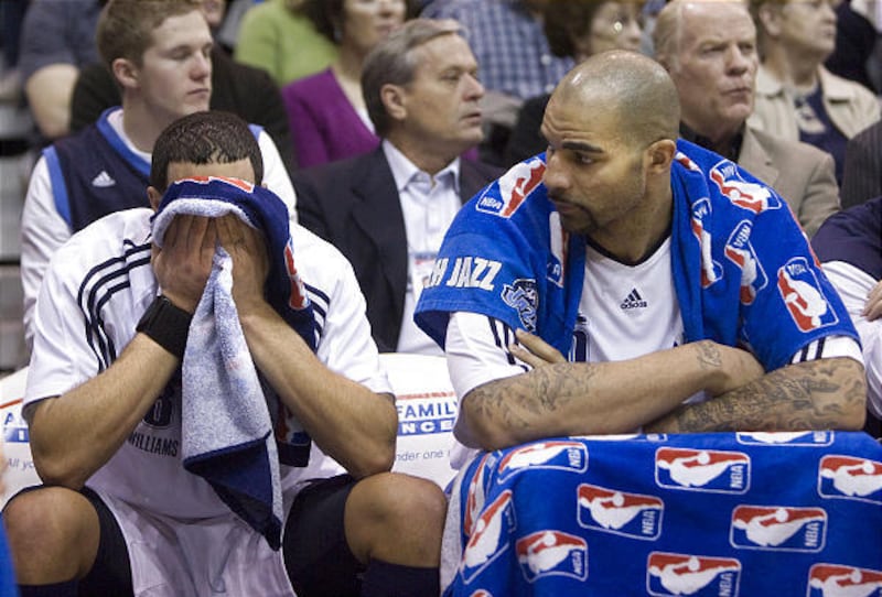 Deron Williams and Carlos Boozer spend the final 2 minutes of the game from the bench during the game with the Los Angeles Lakers at the Energy Solutions Arena in Salt Lake City on Feb., 10, 2010.