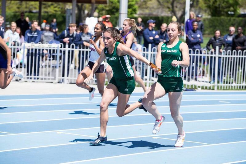 Utah Valley junior Alena Gillespie (left-center) receives the baton on the exchange from freshman Angela Cardon (right-center) in the women's 4x100 relay at BYU's Robison Invitational on Saturday.