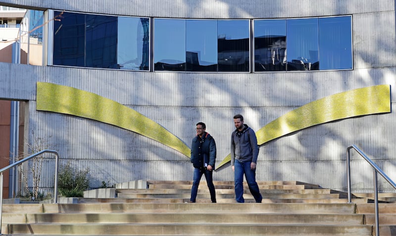 Two man standing in front of concrete Amazon building