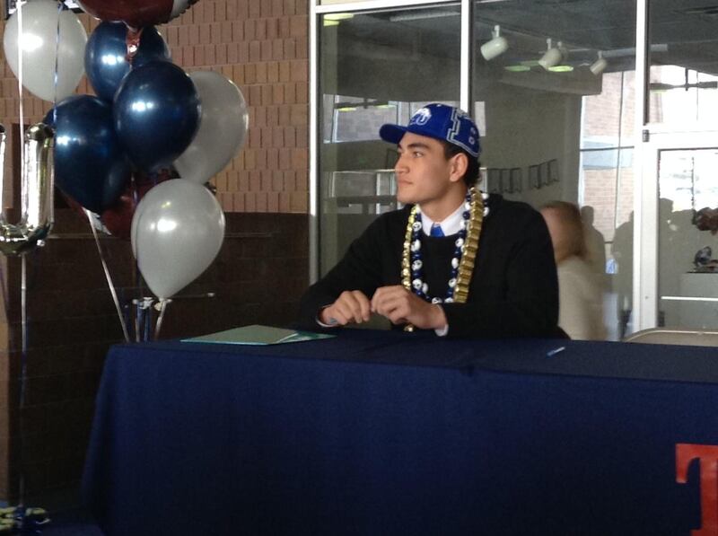 Timpview's Keenan Pili prepares to sign a letter of intent to play football at BYU on Signing Day.