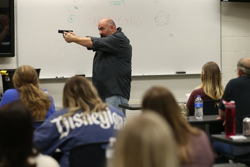Detective Justin Mortensen shows schoolteachers how to stand when firing a gun during a class at the Utah County Sheriff's Office in Spanish Fork on Wednesday, June 12, 2019.