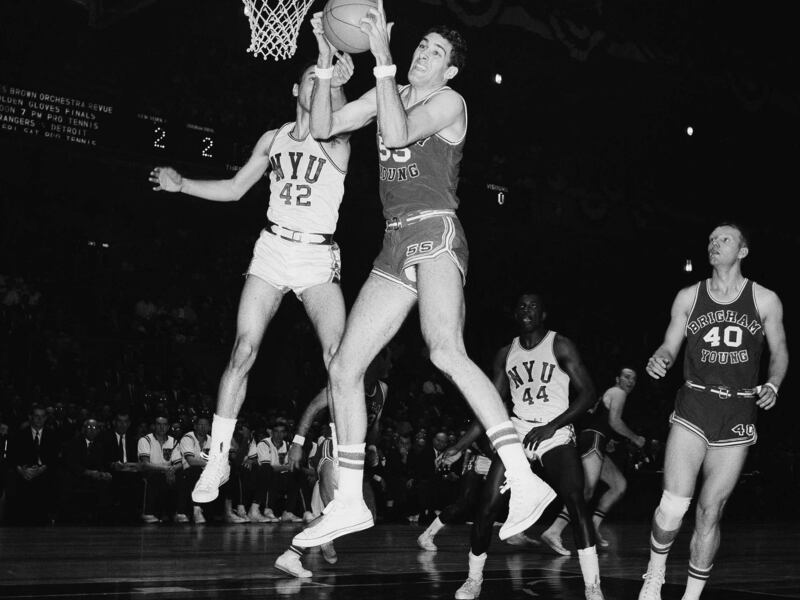 Craig Raymond of Brigham Young, 55, beats NYU?s Charlie Silen, 42, to the rebound in first half of National Invitation Tournament Championship Game at Madison Square Garden in New York on March 19, 1966. Stan McKenzie of NYU, 44, is at right background. B
