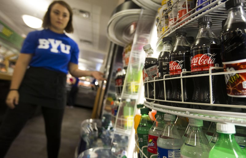 Tatelyn Ferguson restocks caffeinated soda at the Cougar Express on the Brigham Young University campus in Provo on Thursday, Sept. 21, 2017. The Mormon church–run college is breaking a 60-year-old tradition by offering caffeinated sodas on campus.