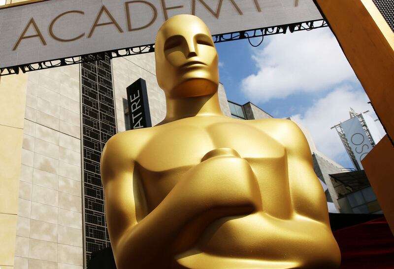 In this Feb. 21, 2015 file photo, an Oscar statue appears outside the Dolby Theatre for the 87th Academy Awards in Los Angeles. Some people watch awards shows out of love, others because they love to hate. But this year, as ratings have taken a dive, will anybody tune in to the Oscars?
