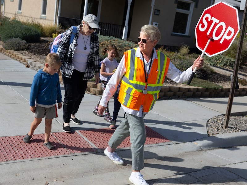 Arlee Willits helps Emerson Elementary School students and family members cross 1100 East in Salt Lake City on Oct. 25, 2023.