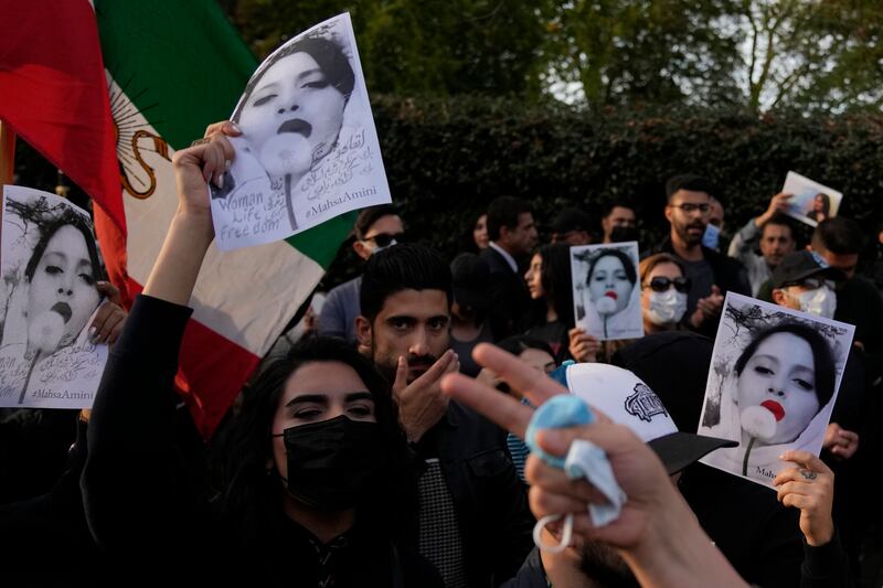 Demonstrators hold placards outside the Iranian Embassy in London.