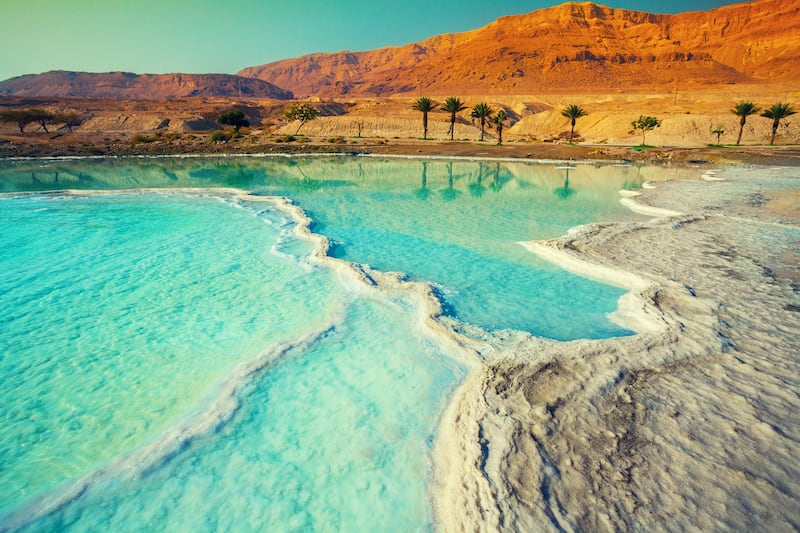 Flash floods unleashed by heavy rains swept away a group of middle school students and teachers visiting hot springs near the Dead Sea on Thursday, killing 18 and injuring 35 as the torrent carried some for several kilometers, a civil defense official sai