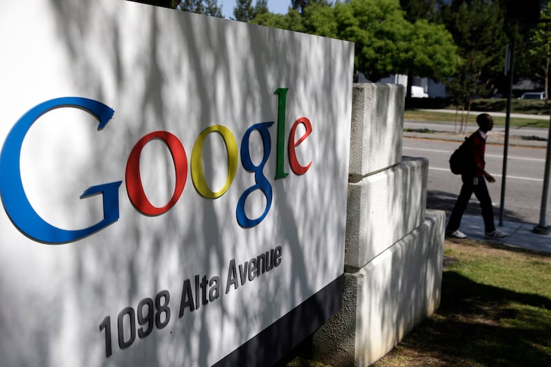 A man walks past a Google sign at the company’s headquarters in Mountain View, California, on June 5, 2014.