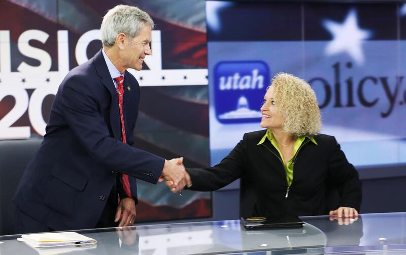 FILE — Salt Lake City Mayoral candidates Mayor Ralph Becker and Jackie Biskupski shake hands after a debate during a KSL TV and KSL Newsradio hosted event in Salt Lake City Wednesday, Oct. 14, 2015.