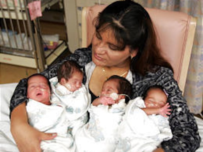Mirna Tabarez holds her four new babies as she talks about the birth of the quadruplets in Provo. She and her husband spent their savings on in-vitro fertilization.