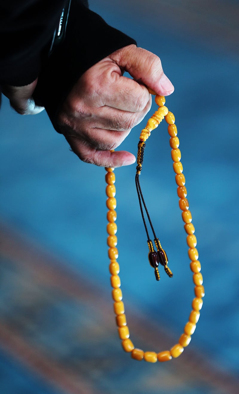 Adeeb Sami holds tasbeeh counting beads as he stands in the Al Noor Mosque in Christchurch, New Zealand, in May 2019.