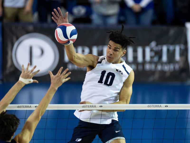 Sophomore Gavin Julien spikes a ball during match against UC Irvine on Jan. 21 at Smith Fieldhouse in Provo.