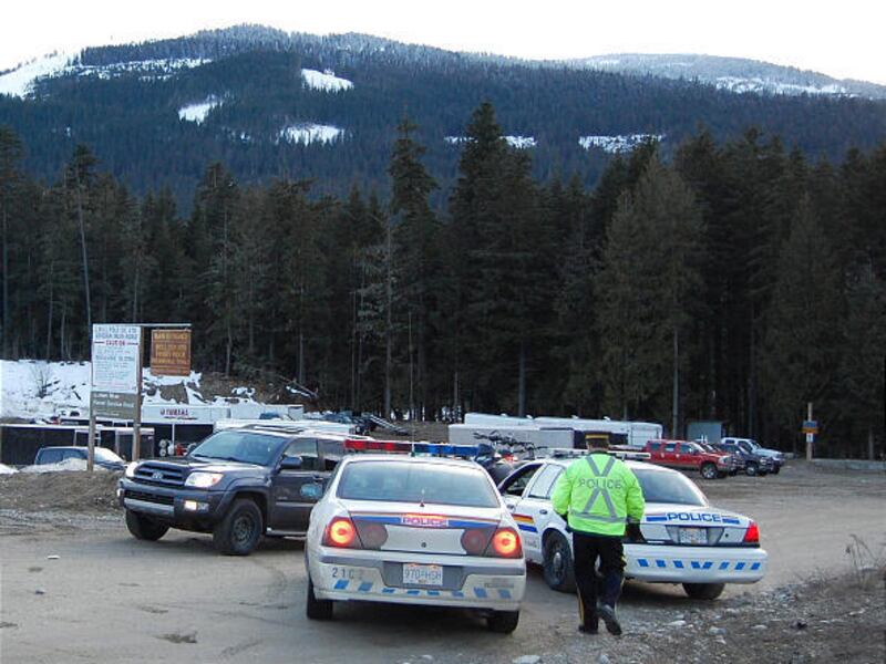 Royal Canadian Mounted Police direct traffic at the staging area for avalanche search & rescue operations near Revelstoke, B.C. on Saturday.