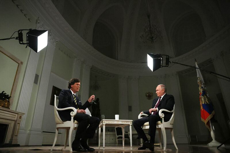 Russian President Vladimir Putin, right, listens to a question during an interview with former Fox News host Tucker Carlson at the Kremlin in Moscow on Feb. 6, 2024.
