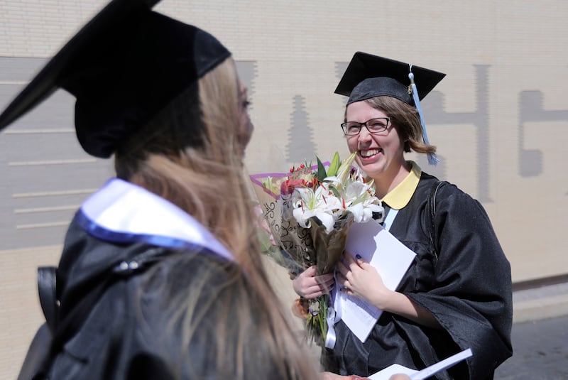 Erika Jensen and Taya Curtis chat after Utah State University's commencement ceremony outside of the Dee Glen Smith Spectrum in Logan on Thursday, May 2, 2019.