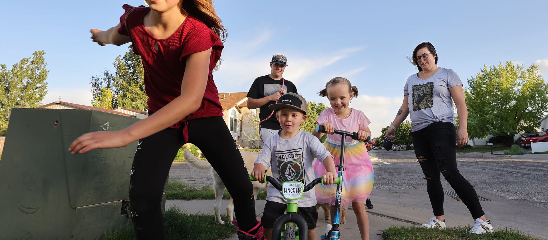 Tyler and Stephanie Parkin walk and bike with their three kids near their home in Roy, Utah, in May 2021.