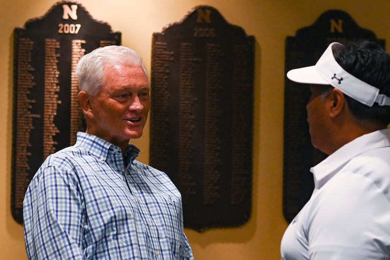 Navy Midshipmen athletic director Chet Gladchuk Jr. speaks with football head coach Ken Niumatalolo during Navy Football Fanfest.